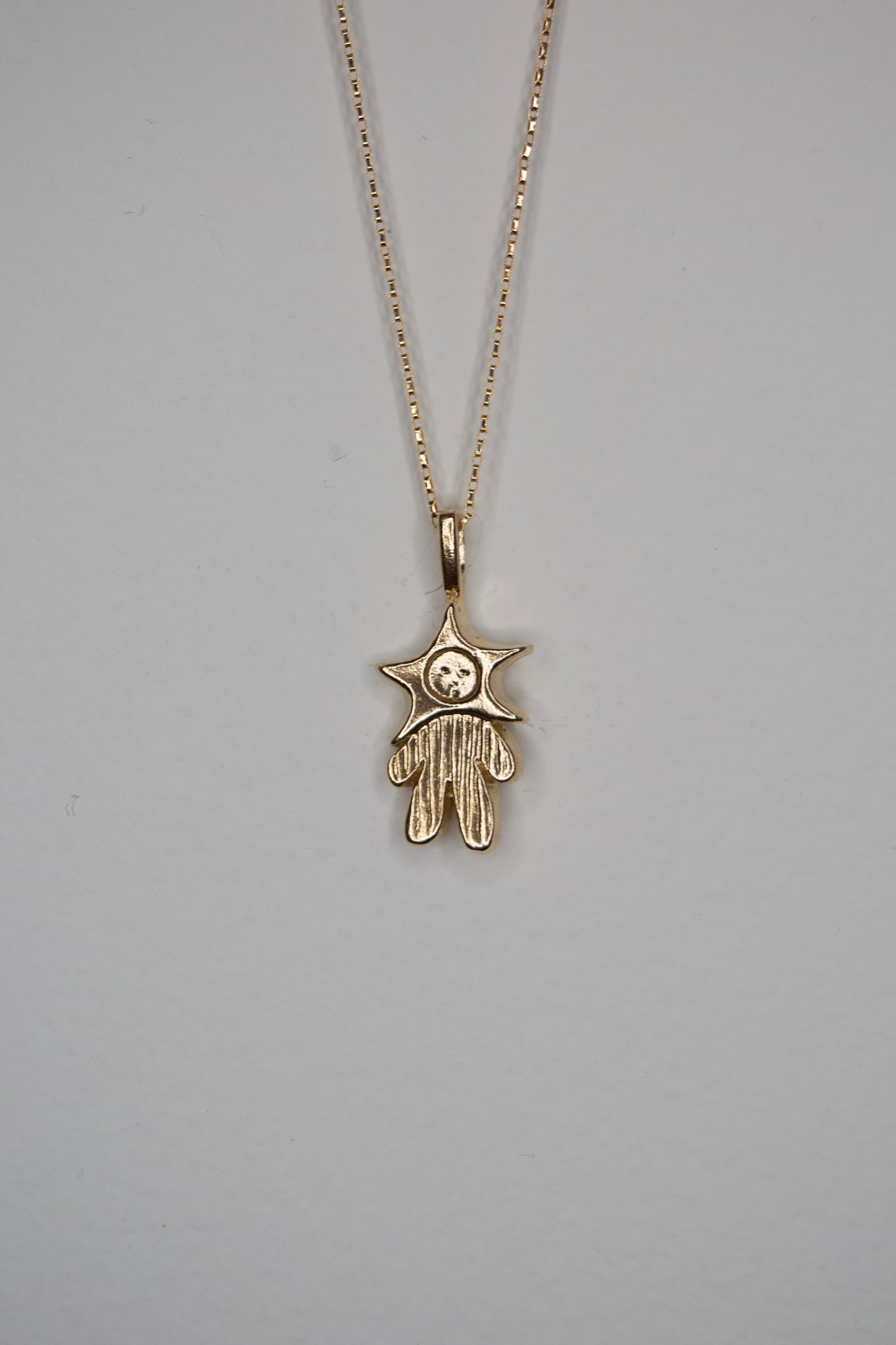 GOLD TONE PINSTRIPED STAR BABY