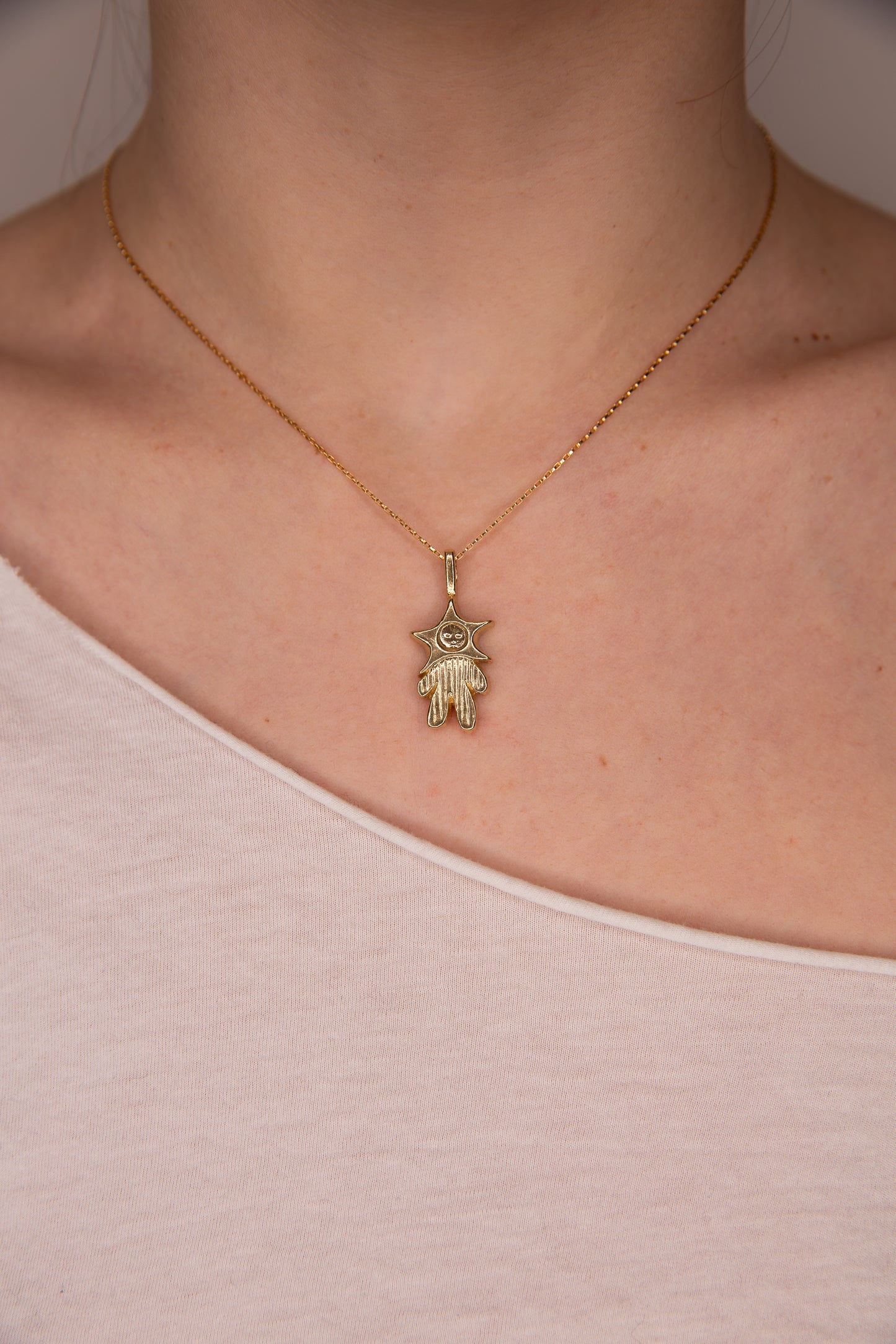 GOLD TONE PINSTRIPED STAR BABY